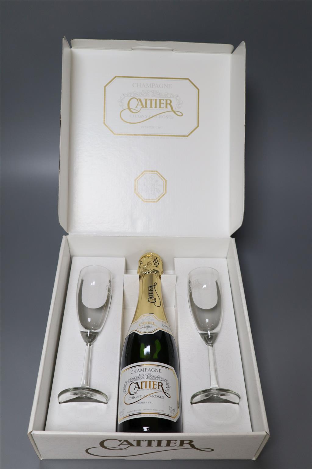 A carton of four individual presentation boxes containing a half bottle of Cattier Champagne with two champagne glasses